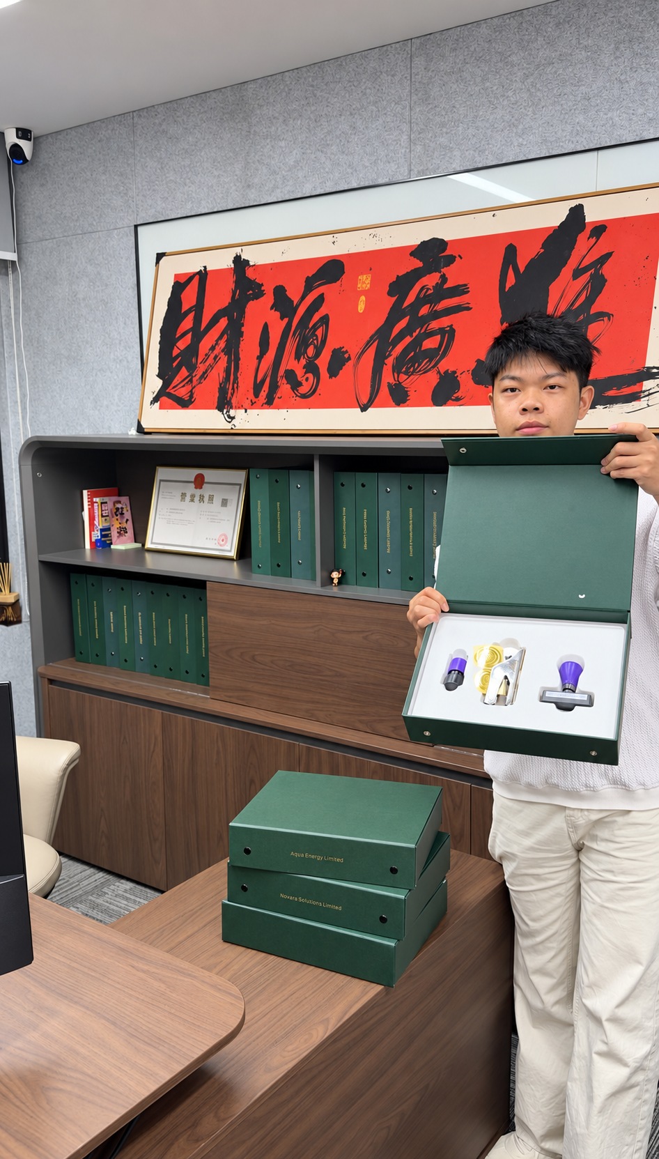 A Luminos team member presenting the company kit and stamps in the office